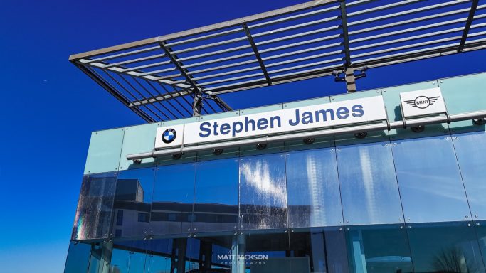 Signage for Stephen James dealership with a clear blue sky in the background.
